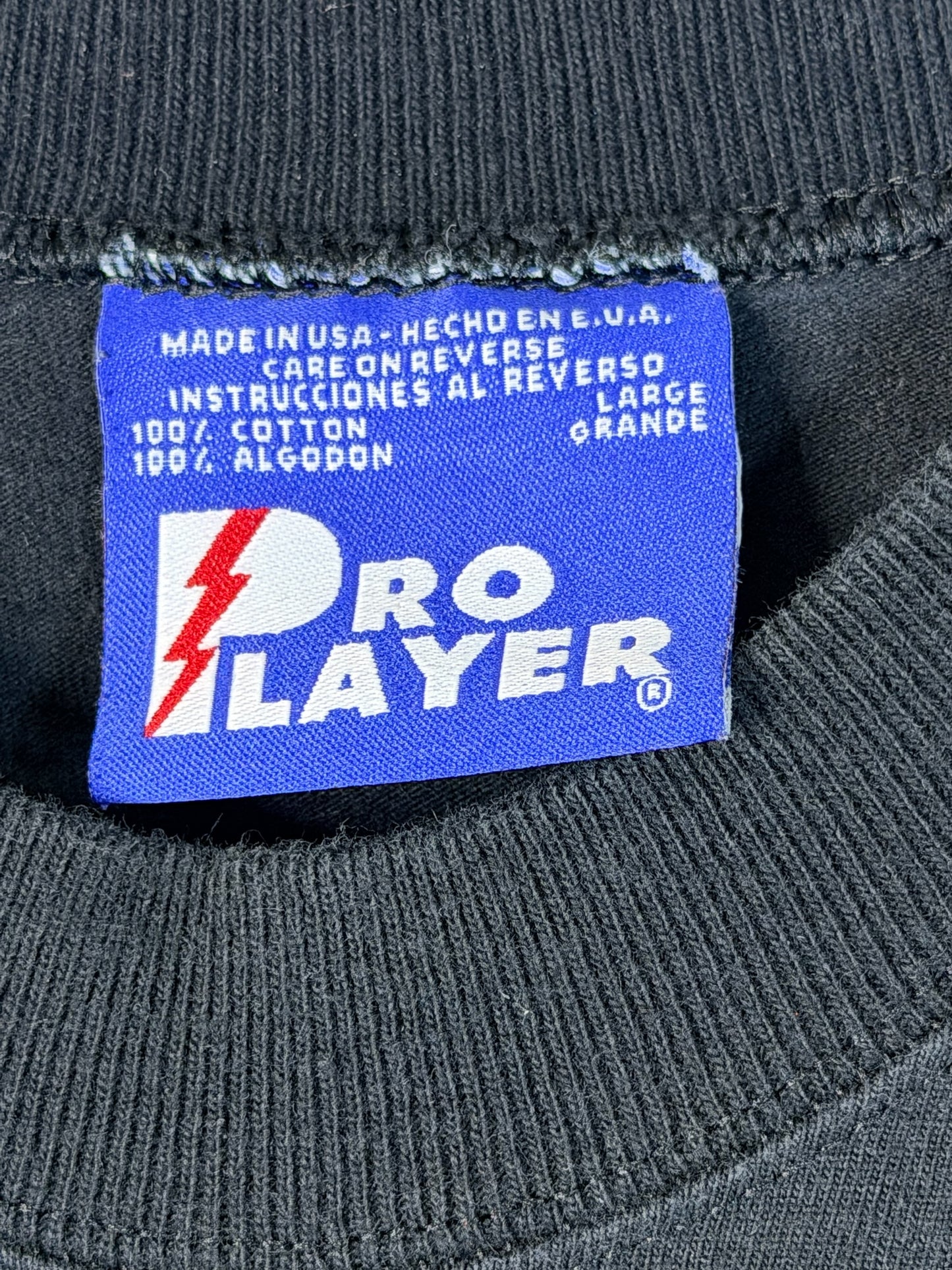 Brass Monkey Vintage Pro Player blue fabric tag on a black cotton t-shirt with Made in USA and size large details