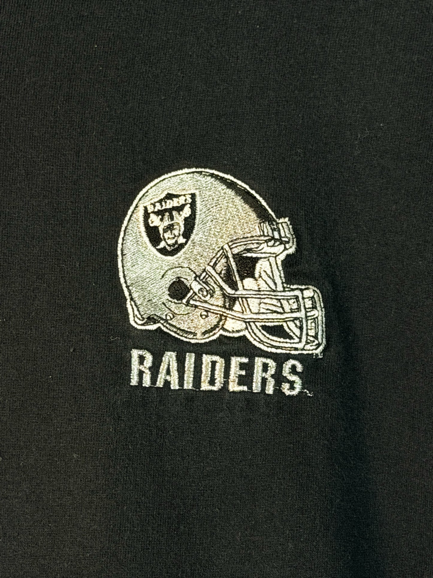 Brass Monkey Vintage black cotton t-shirt featuring an embroidered Las Vegas Raiders helmet logo on the chest.